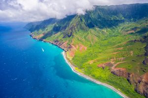 aerial view of a tropical Hawaiian beach bordered by lush mountains