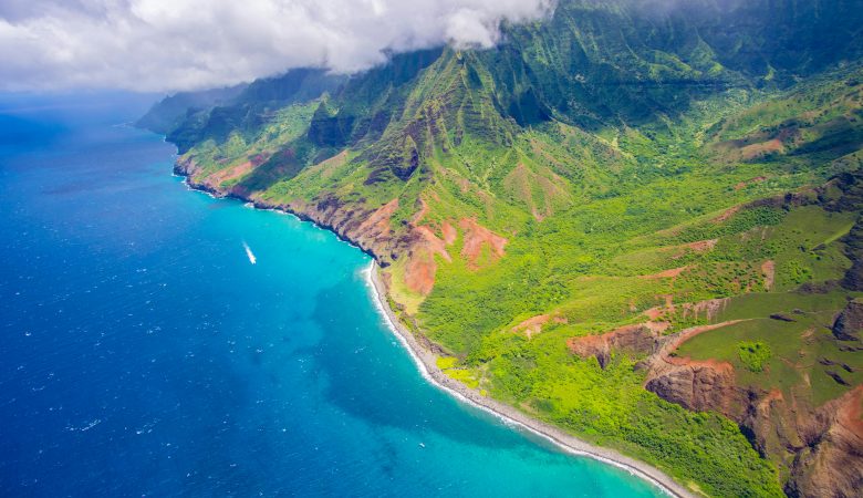 aerial view of a tropical Hawaiian beach bordered by lush mountains