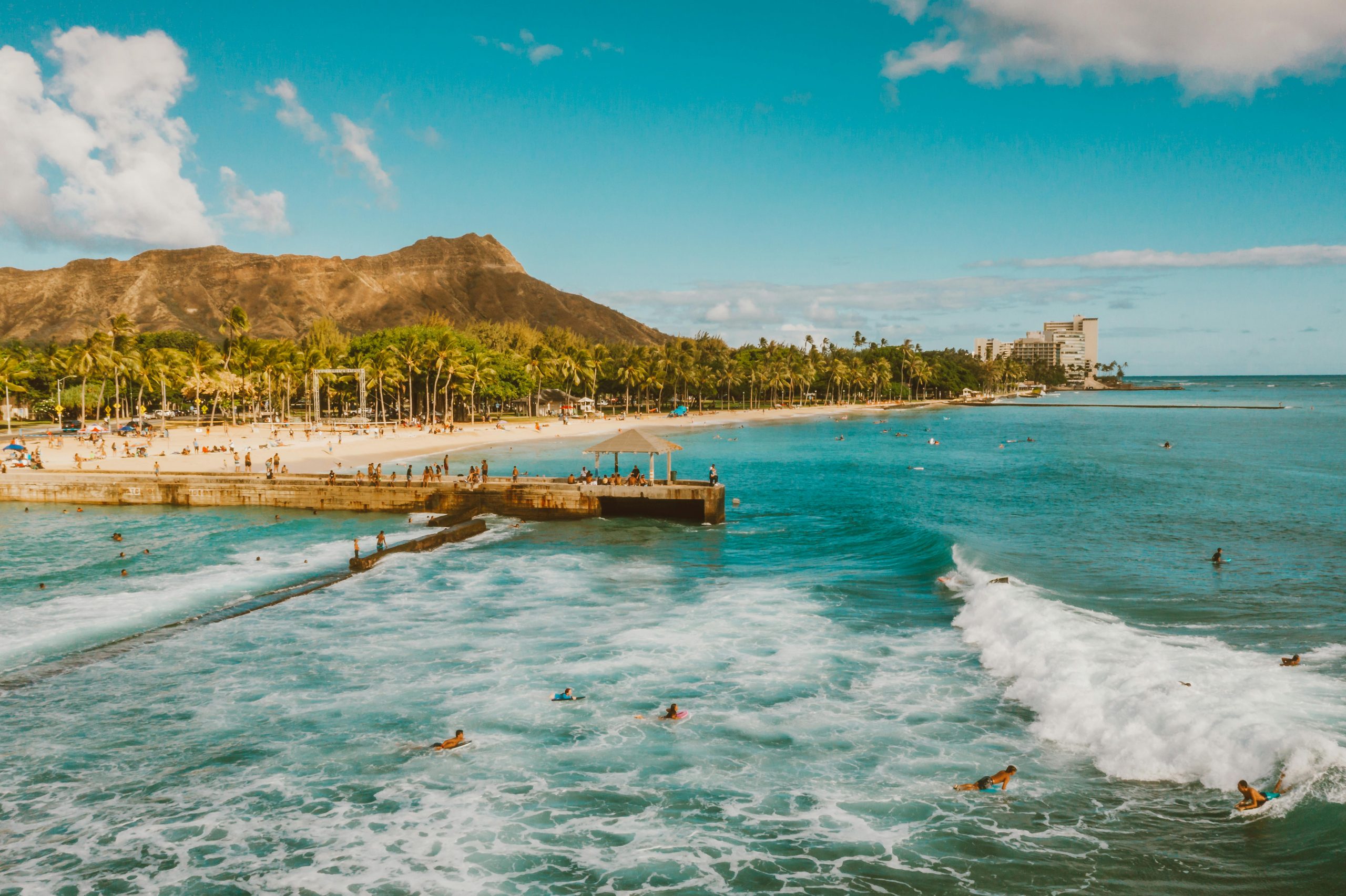 beachgoers swimming and surfing at Honolulu
